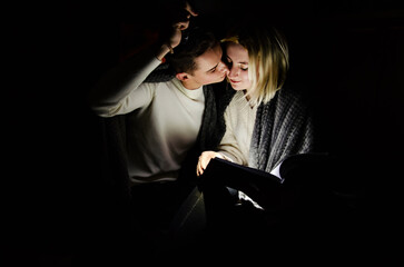 A couple in love at home during a power outage. Blackout, no electricity