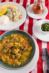 Restaurant table with pork tripe soup with rice and vegetables