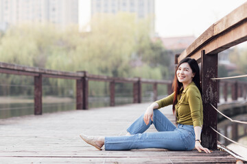 Fototapeta na wymiar Candid lifestyle Portrait of happy young beautiful asian sexy woman enjoying life outdoor at spring. Smiling millennial girl with perfect clear glow skin and long brunette hair
