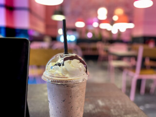 Chocolate milkshake next to a bar in a coffee shop