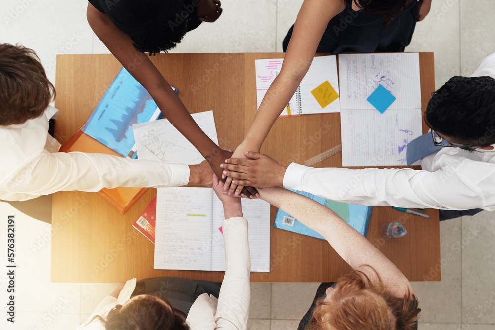 Poster teamwork and success go hand in hand. shot of a group colleagues reaching their hands forward togeth