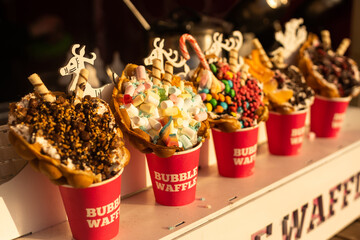 Fresh belgian waffles on Christmas market. Street food on traditional Xmas fair.