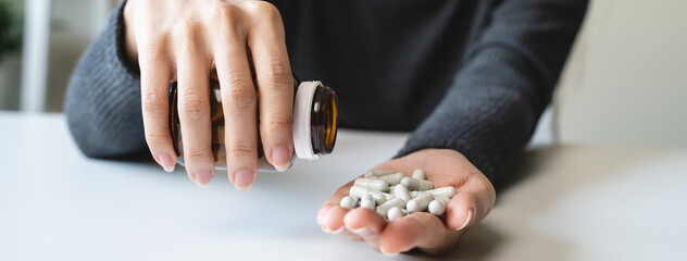 close up hand of young women. Stressed female taking drug overdose.