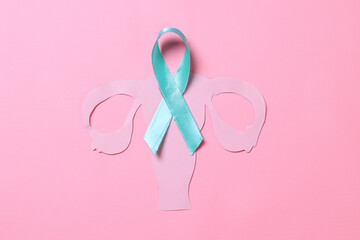 Teal awareness ribbon with cervix shape over pink background with copy space. Ovarian Cancer month, cervical cancer day.  - obrazy, fototapety, plakaty
