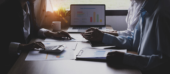 Technology and financial advisory services concert. Business teamwork and working on digital laptop computer with advisor showing plan of investment to clients at table office. Digital marketing.