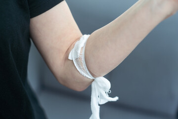 cotton alcohol closed on arm after blood donation