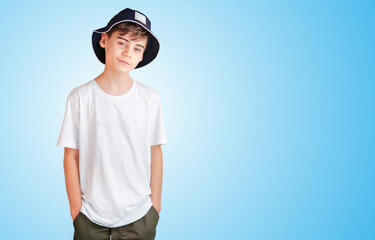 Portrait of nice cheerful smiling 10-year-old boy isolated on blue background in white shirt. back to school concept mit copy space for text. clever schoolboy exudes joy. back-to-school banner