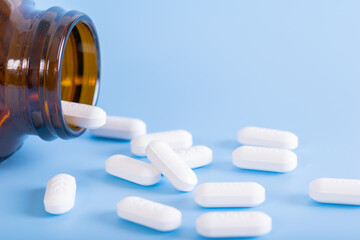 close up of medicine pills on blue background