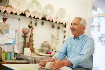 Craftiness and happiness. Shot of a senior man making a ceramic pot in a workshop.