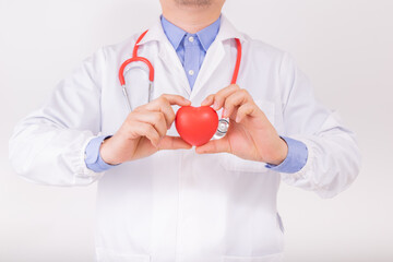 Doctor wear white lab coat with red stethoscope and holding red heart by two hands. Cardiology healthcare, healthy heart protection, cardiac diseases concept