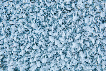Fototapeta na wymiar Ice crystals close up. Macro photo of a frozen surface.