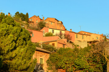 Famous ochre colored houses of Roussillon village in Provence countryside, France - 576386362