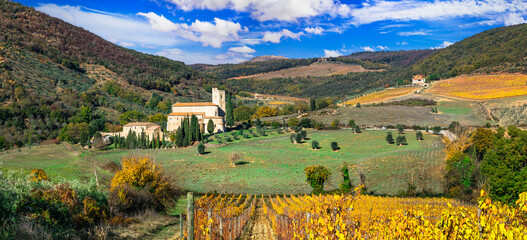 Italy, Toscana autumn scenery . Golden vineyards of Tuscany.  panorama of old monastery and yellow...