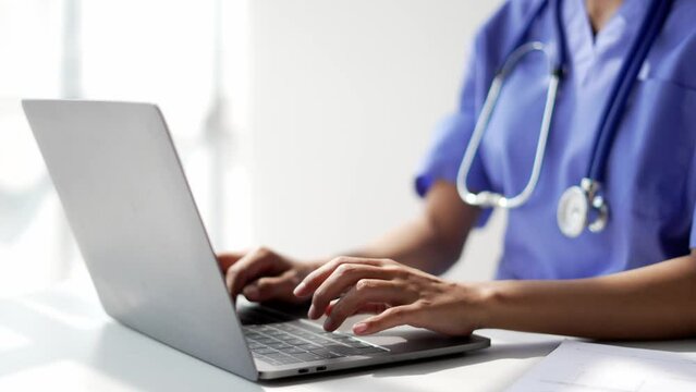 Female doctor consulting patient online from clinic office. Giving medical prescriptions by internet.