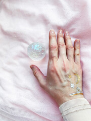 Background Healing minerals, stones, crystals. the practice of magic spells and cleansing. Crystal Ritual, Witchcraft. Hand holds beautiful quartz crystals in the shape of the moon.
