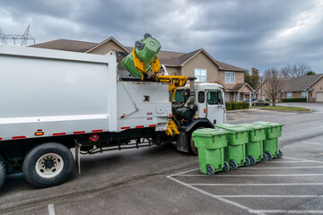 Naklejka premium Garbage Truck Picking Up And Dumping Residential Trash Containers