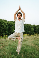 young man doing yog in nature, balance exercise 2