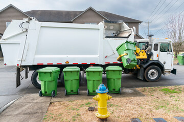 Automated Garbage Truck Picking Up Trash Container on Curb