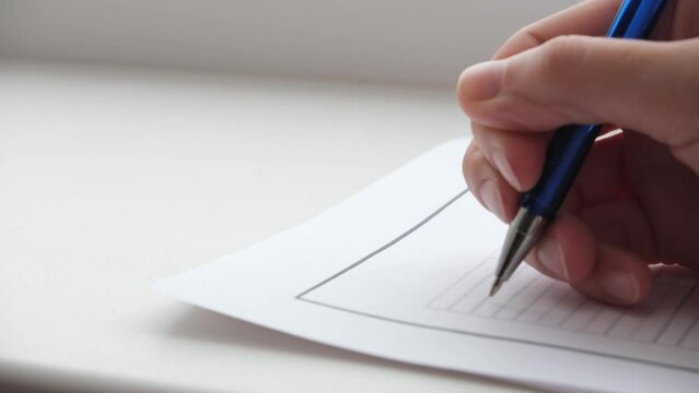 The hand signs documents or fills out a form. Puts a signature. Close-up 4k footage 25 fps