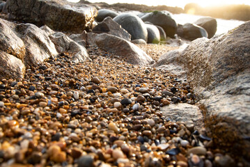 Low view of expanse of gravel and rocks in cool late afternoon light at Porto beach - Portugal