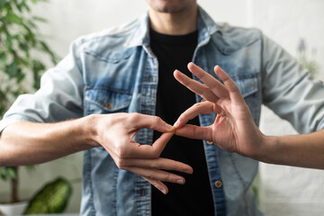 Sign language interpreter man translating a meeting to ASL, American Sign Language. Empty copy...