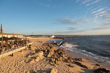 Social life by the sea on a beautiful beach at the mouth of the Ave river in Vila do Conde, Portugal