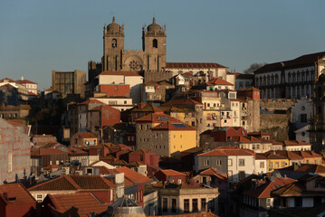 Fototapeta na wymiar Cathedral, roofs and yellow houses at sunset in Porto, Portugal