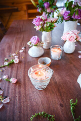 border detail of roses and lilies from above on a wooden table - design element with candles spa vibes