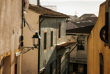 Detail of an alley in Vila do Conde, old lamp and ceramic on the facades Porto, Portugal