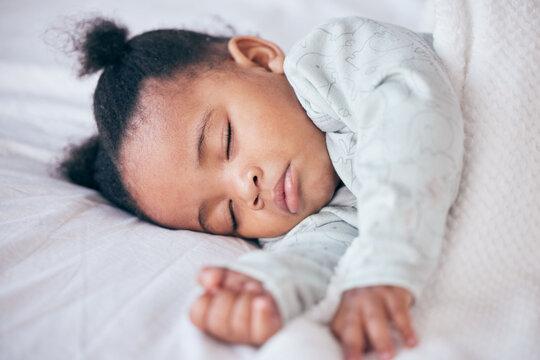 Black girl, baby and sleeping in bedroom, home and nursery room for peace, calm and dreaming at nap time. Tired young female kid asleep for resting, break and healthy childhood development in house