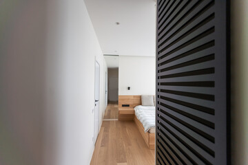 Fototapeta premium Hotel interior room, Condominium or apartment doorway with open door in front of blur bedroom background.