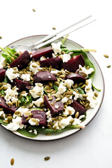 Beetroot and spinach salad with feta cheese and squash seeds