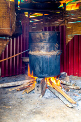 Vietnam, traditional cooking on open fire place.