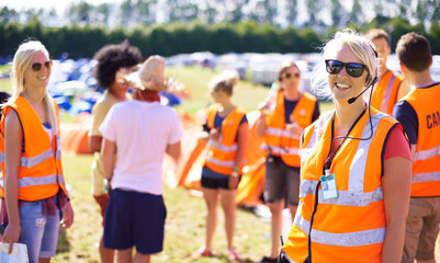 Making sure the event goes off without a hitch. Shot of a beautiful young woman working as an event assistant at a music festival.