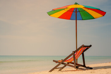 Deck chair with an umbrella.tropical sandy beach, summer travel, vacation and  summer holiday concepts.