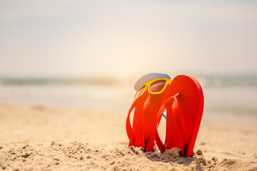 Women yellow sunglasses and red flip-flops on sandy. Travel by sea. Beach vacation.tropical sandy...