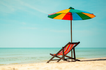 Deck chair with colorful an umbrella.tropical sandy beach, summer travel, vacation and summer holiday concepts.