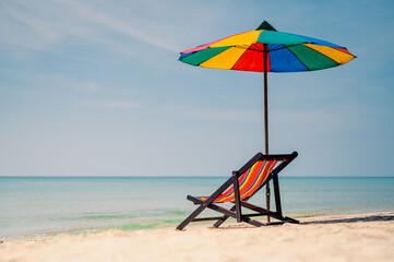 Deck chair with colorful an umbrella.tropical sandy beach, summer travel, vacation and summer holiday concepts.