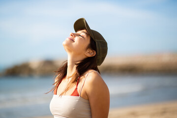 Fototapeta na wymiar Young woman enjoying a sunny day on beach