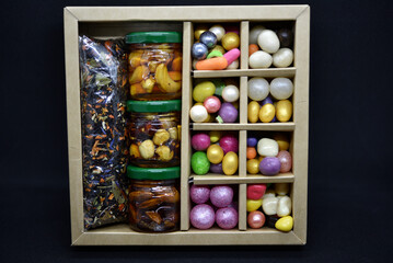 A gift set of sweets and nuts in honey. Delicious sweets. Colorful sweets.