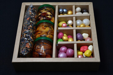 A gift set of sweets and nuts in honey. Delicious sweets. Colorful sweets.