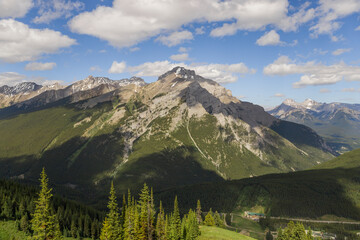 Fototapeta premium Natural landscape - Bow River Valley, Rocky Mountains, coniferous forest and beautiful sky with clouds. Summer tourism in the mountains
