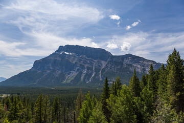 Obraz premium Natural landscape - Bow River Valley, Rocky Mountains, coniferous forest and beautiful sky with clouds. Summer tourism in the mountains