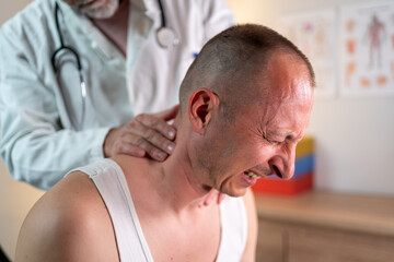injured  man touching neck near doctor on blurred foreground