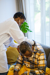 Young doctor doing a consultation at the home of the elderly patient to preserve his state of health and take care of himself. Concept: Health care, doctor at home, auscultation - obrazy, fototapety, plakaty