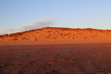 Tall orange sand dune on beach