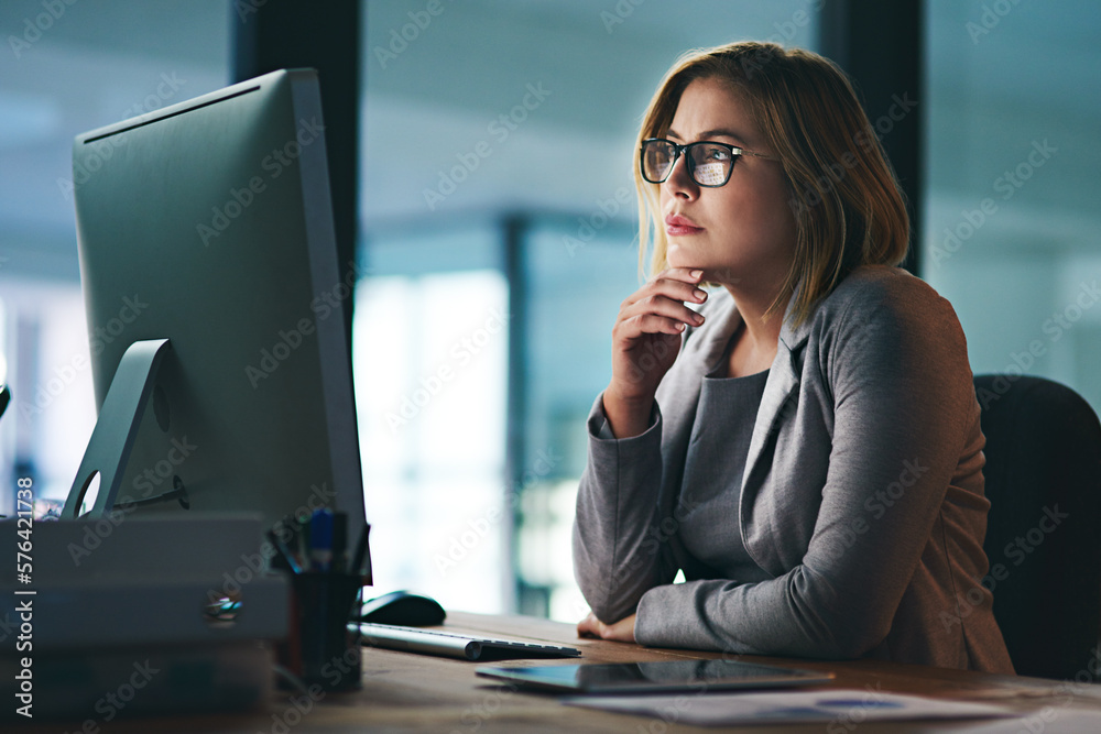 Poster she thinks through every challenge carefully. shot of a young businesswoman working late on a comput