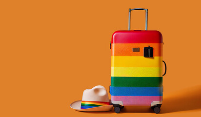 Trolley suitcase decorated with the colors of the LGBT flag and straw hat