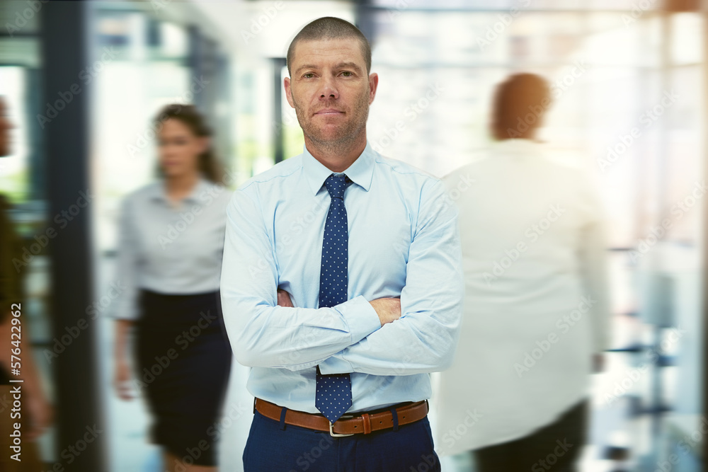 Poster success is something you need to keep in motion. portrait of a mature businessman standing in a busy