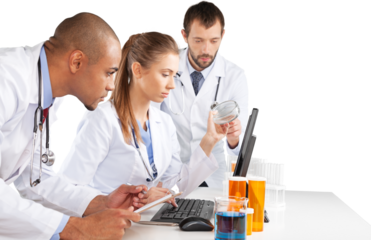 Portrait of Doctors Looking at Laptop and Writing on Clipboard